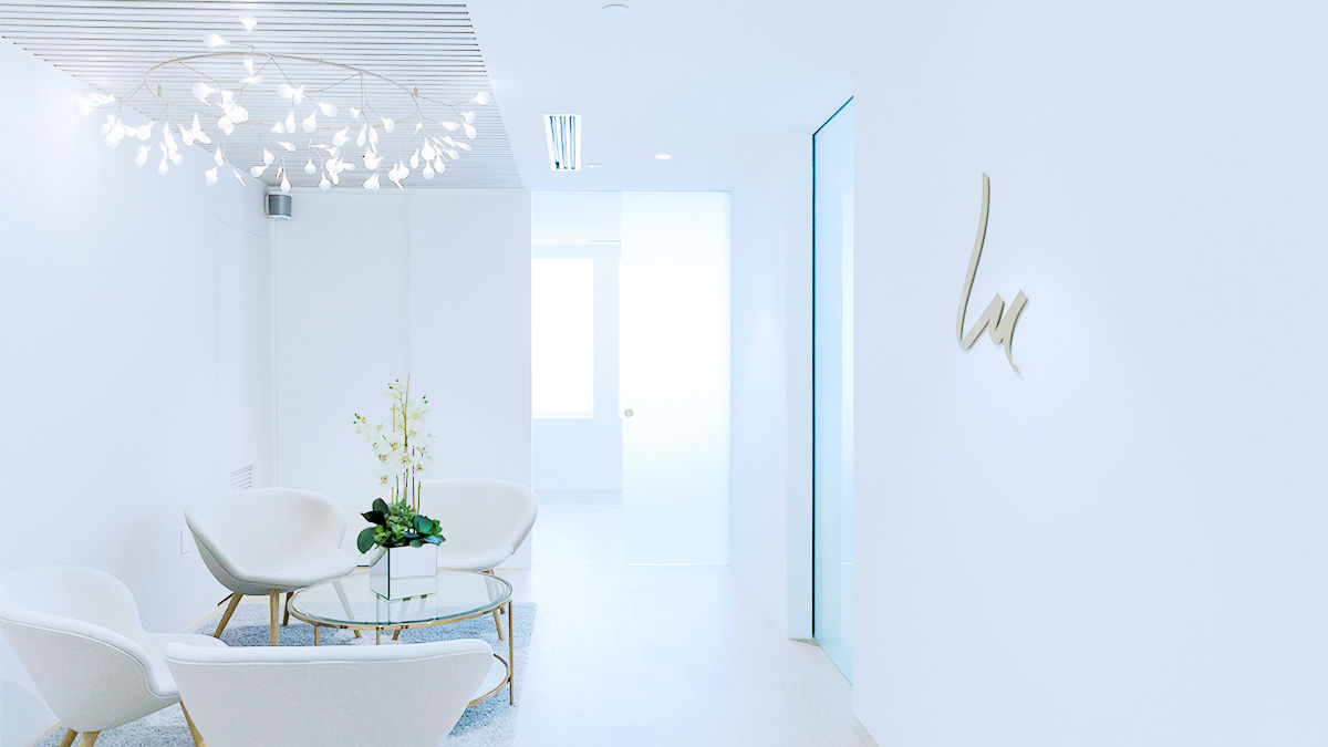 Waiting area with desk and chairs in a dental practice.