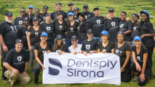 A group of Dentsply Sirona employees holding a banner for the Build Your Smile Foundation