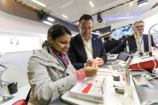 Dentsply Sirona employee interacts with customer at IDS 2019