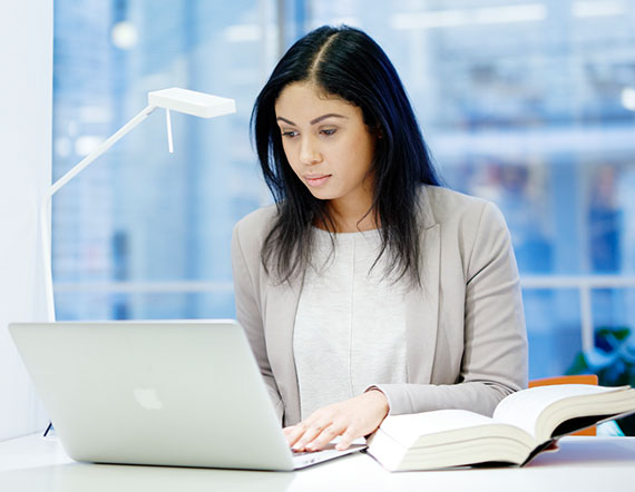 Woman reading scientific documentation on computer