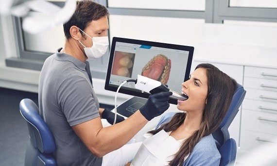 Dentist scanning patient with Primescan