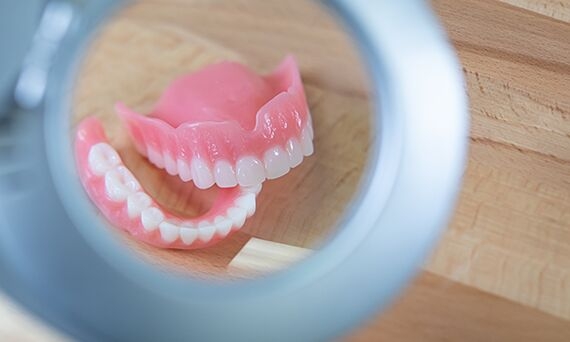 Denture under magnifying light