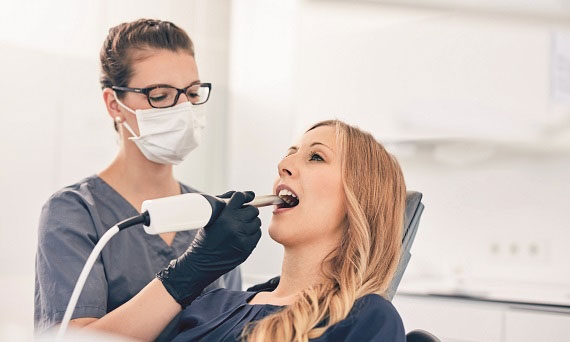 Dentist scanning female patient with Omnicam