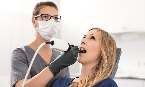 Dentist scanning patient with Omnicam