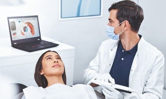 Dentist scanning female patient with Uniscan