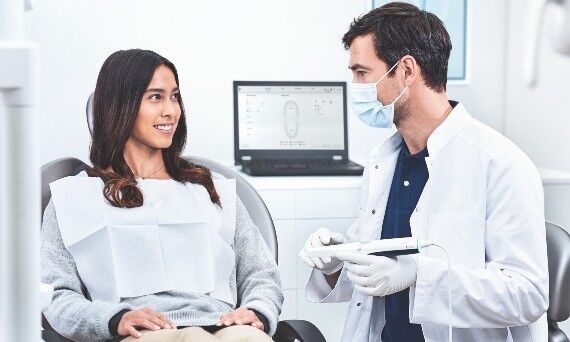 Uniscan intraoral scanner, male dentist and female patient