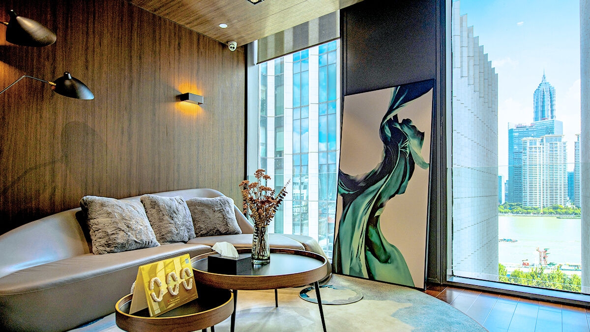 Exquisite waiting room with dark wood floors, full-length windows and tasteful artwork.
