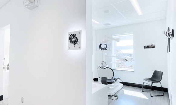 View from the hallway into a modern treatment room with an Intego Pro treatment center. 